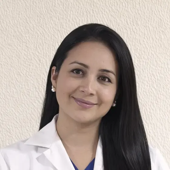 Mgtr. Katherine Martínez sonriendo con bata blanca